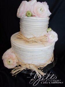 raffia and fresh flowers on engagement cake